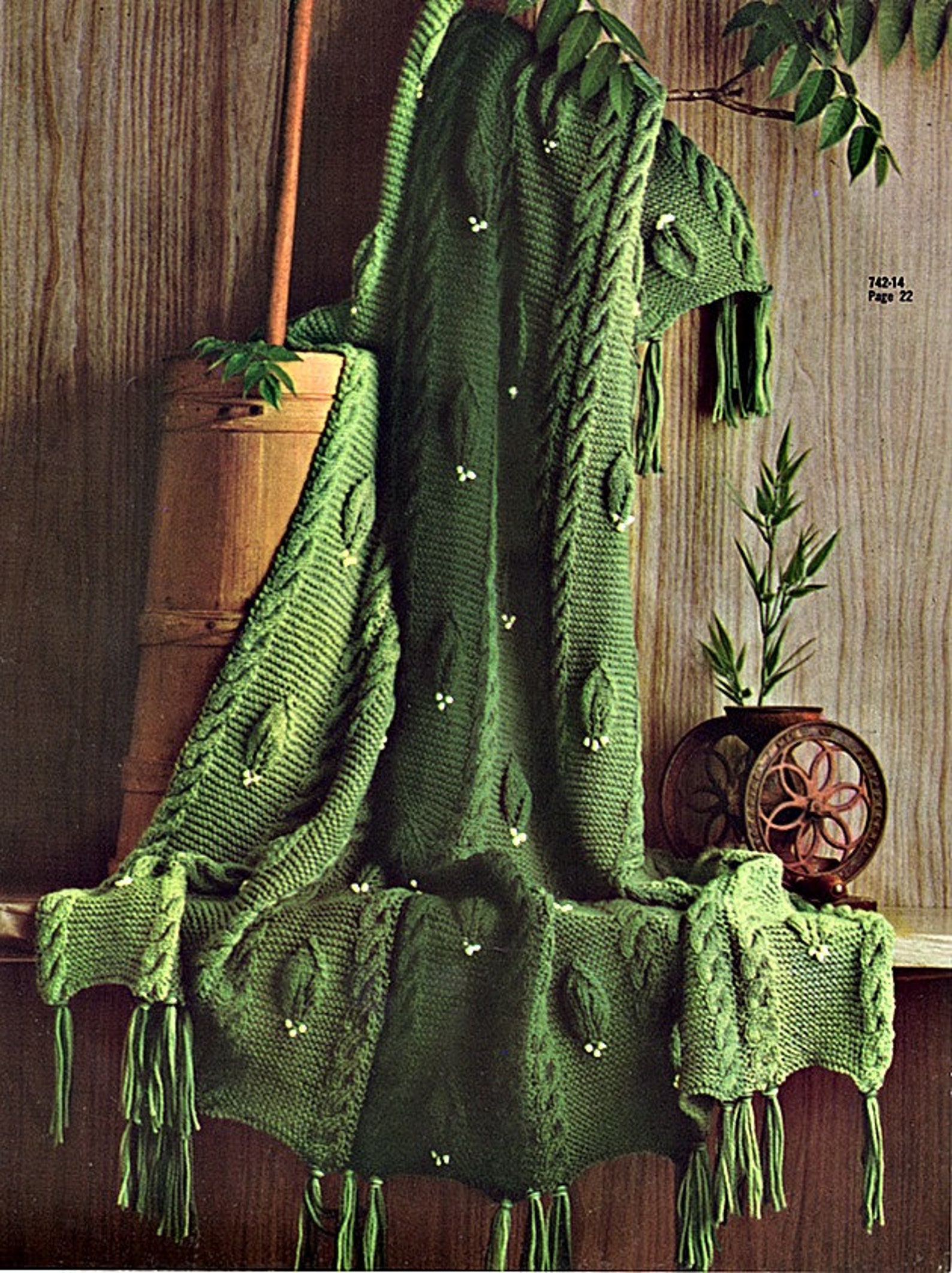 Rustic green leaf blanket knitting pattern in garter stitch and cable
