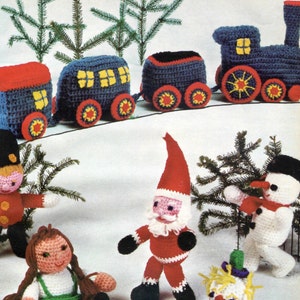 Peut inclure: Un train de Noël en crochet avec un wagon de queue rouge, des wagons bleus et une locomotive bleue. Il y a aussi des figurines en crochet d'un bonhomme de neige, du Père Noël, d'une fille et d'un soldat de jouet.