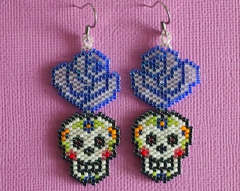 rose and sugar skull beaded earrings! Day of the Dead beadwork earrings. Delica skull earrings with lavender and blue roses. skull jewelry