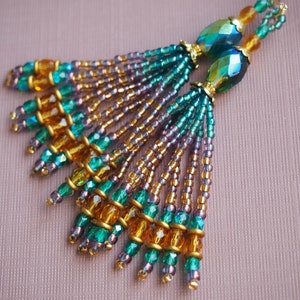 flashy teal green and gold hand beaded tassel earrings! with purple accents. iridescent finished Czech glass tassel earrings. beaded fringes