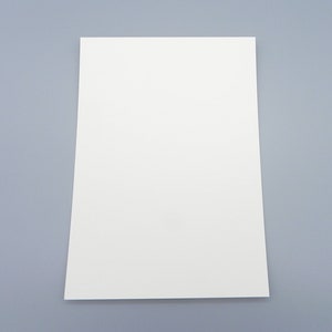 May include: A blank white sheet of paper on a light gray background.