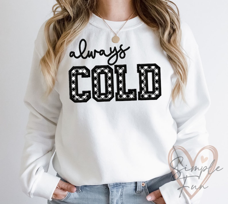 May include: White sweatshirt with black and white checkered text that reads "always COLD".