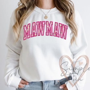 May include: White sweatshirt with a pink floral print and the text "MAWMAW" in pink letters.