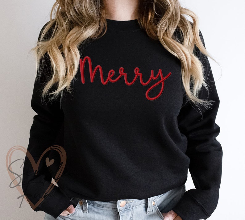 Pu&ograve; includere: Felpa nera con la parola "Merry" in lettere corsive rosse.