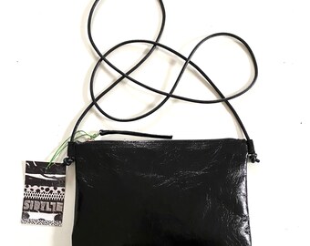 Black glossy leather shoulder bag with leather strap for parties or holidays, adjustable length