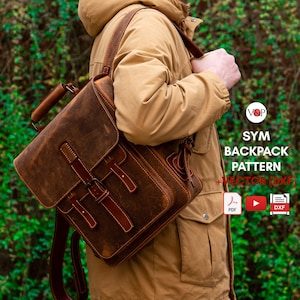 May include: A brown leather backpack with a top handle, a front flap secured by a buckle strap, and adjustable shoulder straps. Text on the right reads V&P SYM BACKPACK PATTERN + VECTOR (DXF) with PDF, YouTube, and DXF file format icons.
