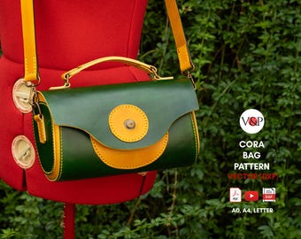 May include: A green and yellow leather bag with a top handle and a shoulder strap. The bag has a circular design on the front and is displayed on a red mannequin. The text "CORA BAG PATTERN" is visible.