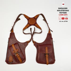 May include: A brown and tan leather shoulder holster bag with two main compartments, adjustable straps, and buckle closures. Text on the image reads: SHOULDER HOLSTER BAG PATTERN LASER (DXF), A0, A4, LETTER. The design features stitched edges and metal hardware.