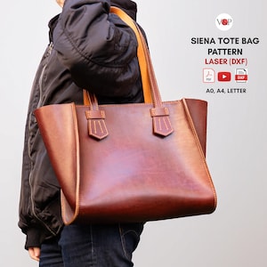 May include: A brown leather tote bag with tan handles and accents. The bag has a rectangular shape with a wide opening and is being carried by a person. The text "SIENA TOTE BAG PATTERN LASER (DXF)" is visible.