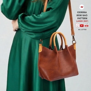 May include: A brown leather mini bag with a shoulder strap and wooden handles. The bag has a textured appearance and is paired with a green dress. The image also includes text that reads "GEMMA MINI BAG PATTERN LASER (DXF)".