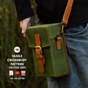 May include: A green leather crossbody bag with a brown leather strap and buckle. The bag has a stitched design and is being held by a person wearing jeans. The text "VASILE CROSSBODY PATTERN VECTOR (DXF)" is printed below the bag.