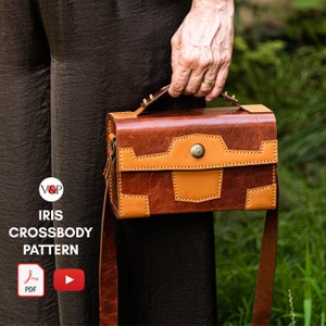 May include: A brown leather crossbody bag with a tan leather flap and a brass buckle. The bag has a top handle and a long adjustable strap. The bag is labeled "IRIS CROSSBODY PATTERN" and has a PDF icon and a play button.