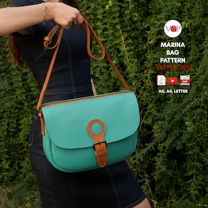 May include: A teal handbag with a brown leather strap and buckle. The bag has a rounded flap and a circular accent on the front. The text "MARINA BAG PATTERN" is visible on the image.