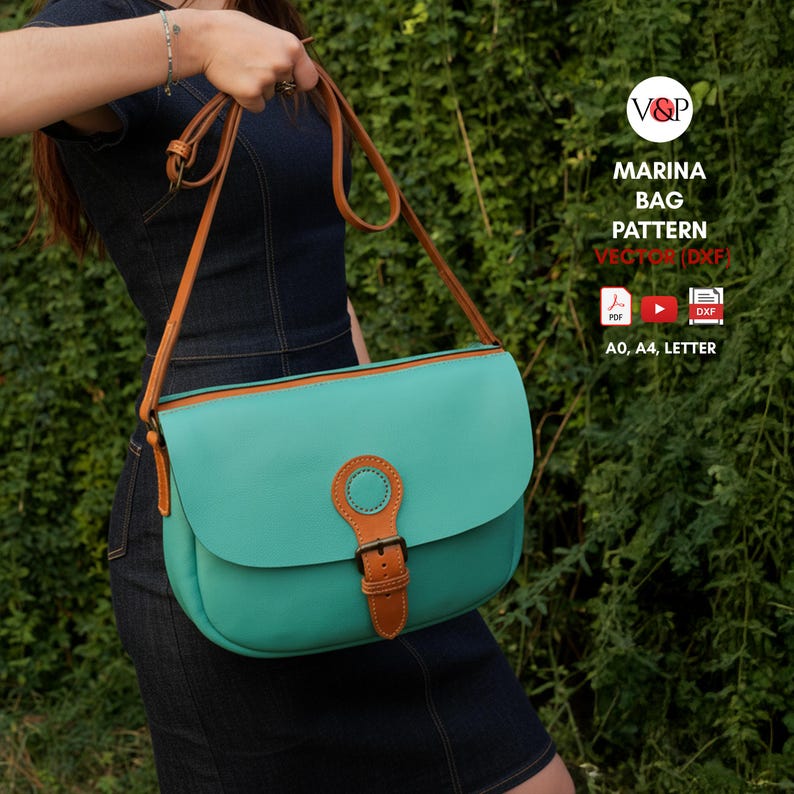 May include: A teal handbag with a brown leather strap and buckle. The bag has a rounded flap and a circular accent on the front. The text "MARINA BAG PATTERN" is visible on the image.