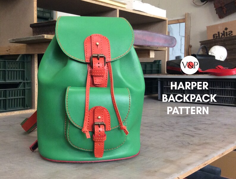 May include: A green leather backpack with orange leather accents and buckles. The backpack has two front pockets and a drawstring closure. The text "HARPER BACKPACK PATTERN" is visible in the image.
