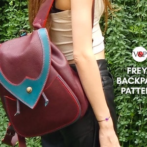 May include: A burgundy leather backpack with teal trim and a flap closure. The backpack has a small pocket on the front and a drawstring closure. The text "FREYA BACKPACK PATTERN" is visible in the image.