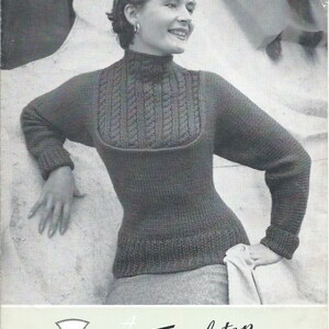 May include: Black and white photo of a woman wearing a gray knitted sweater with a cable knit design. The sweater has a high neck and long sleeves. The woman is standing in front of a stone wall. The photo is from a vintage knitting pattern. The pattern number is 1015 and the price is 6 pence. The bust size is 34-36-38 inches. The yarn is Fisherknit Wool.