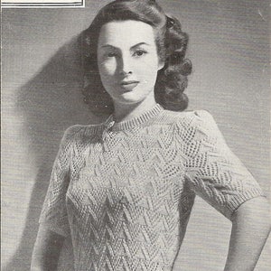 May include: A vintage knitting pattern leaflet for a knitted jumper in a pyramid pattern. The leaflet is titled "Knitted Jumper" and features a black and white photo of a woman wearing the jumper. The leaflet number is 1562.