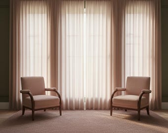 May include: Two armchairs with light pink upholstery and dark wood frames are positioned on a matching pink rug. Behind them are sheer, light pink curtains that cover three large windows, creating a soft, warm atmosphere.