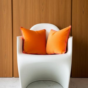 Funda de almohada de terciopelo naranja con ribete rosa intenso