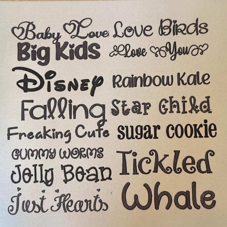 May include: A collection of black text samples in various fonts arranged in two columns. The phrases include Baby Love, Love Birds, Big Kids, Love You, Disney, Rainbow Kale, Falling, Star Child, Freaking Cute, sugar cookie, GUMMY WORMS, Tickled, Jolly Bean, and Just Hearts, Whale.