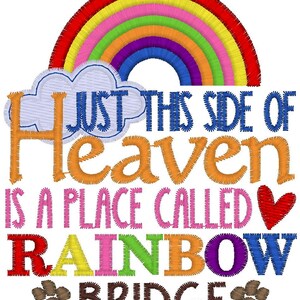May include: An embroidered design featuring a colorful rainbow arching over a light blue cloud. The text reads: JUST THIS SIDE OF HEAVEN IS A PLACE CALLED RAINBOW BRIDGE. The design includes a red heart and two brown paw prints at the bottom.