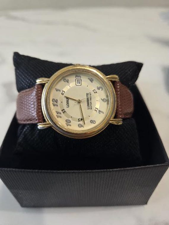 Vintage Lorus Lumibrite Quartz Men's Wristwatch.  Lorus Subrand of Seiko. Round Gold Tone Dial Watch with Brown Leather Strap.