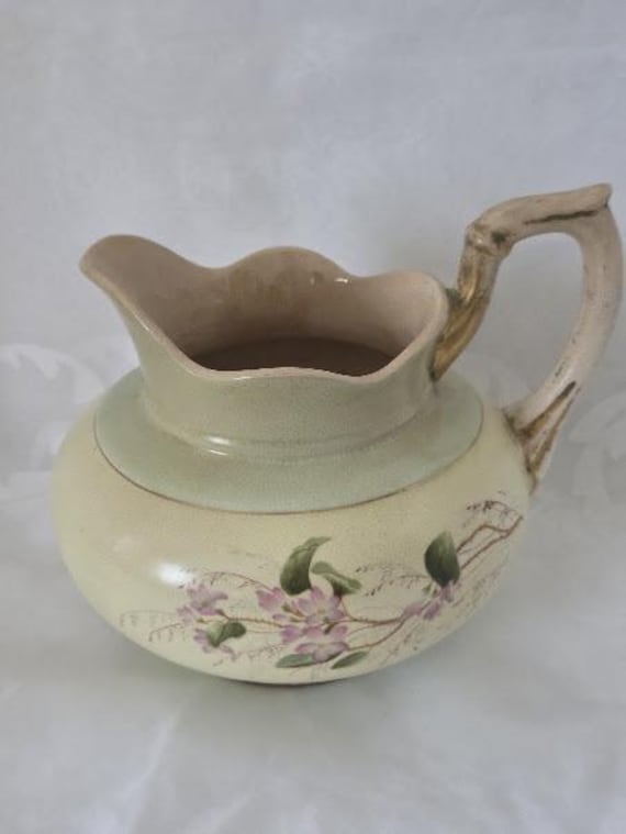 Antique Hampshire Pottery Keene NH Blush Ivory Medium Pitcher with Matte Green and Wild Soft Pink Flowers. Hallmark and signature