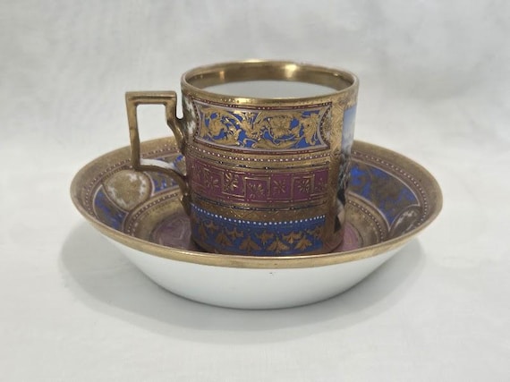 Antique Royal Vienna Demitasse set. Mythological Romantic Scene Heavy gilded scrolled demitasse cup and saucer.