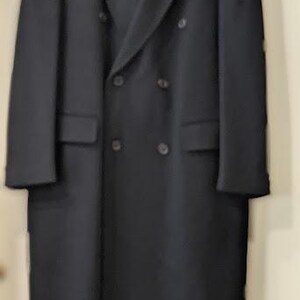 May include: A long, black double-breasted coat with a classic design.