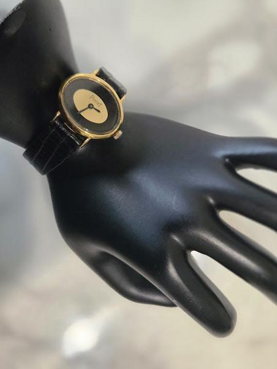 Vintage Plaget Oval Women's Wristwatch Replica. Small Oval Black Gold Face Plaget Watch with Leather Band.