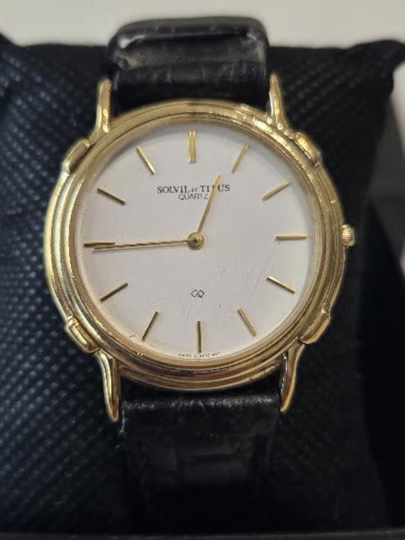 Vintage Solvil et Titus Men's Quartz Wristwatch.  Thin Gold Plated Round White Dial with Black Leather Band Dress Watch.