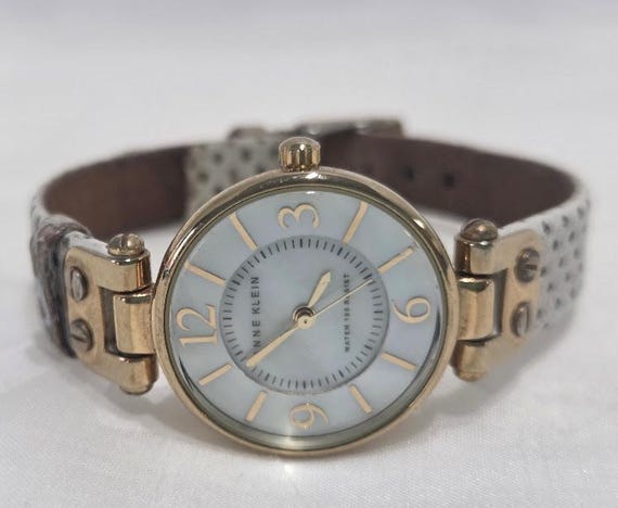 Anne Klein White Shell Round Dial Gold Tone Bezel and Hardware with Leather Band.  Petite style Women's Wristwatch.