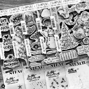 May include: A collection of black and white rubber stamps with winter and holiday themes. The stamps feature images of snowmen, Christmas trees, presents, and a calendar. The text on the stamps includes "Let it Snow", "Joy to the World", "Magical December", "Mr. Frostie", "Santa Visit", "Home for Christmas", "Forest Floor", "Holiday Whatnots", and "December 1931".