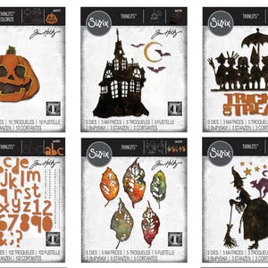 May include: A collection of Sizzix Thinlits dies featuring Halloween-themed designs. Includes a jack-o'-lantern, haunted house, trick-or-treaters, alphabet and numbers, fall leaves, and a witch with a cat. Each die set is on a white background.