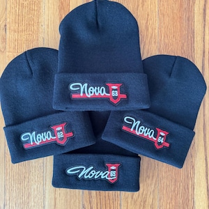 May include: Four black knit beanies with embroidered patches featuring the word "Nova" and a year, 62, 63, 64, and 65.
