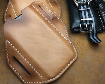 May include: Two brown leather phone cases with white stitching. The cases are made of a soft, supple leather and have a classic design.