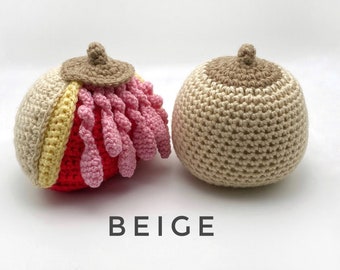 May include: Two crocheted beige and brown anatomical heart models. One model is detailed with pink, red, and yellow yarn.