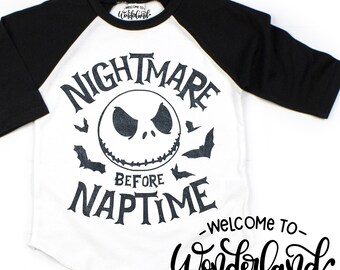 May include: A white and black raglan-style shirt with the words "NIGHTMARE BEFORE NAPTIME", a Jack Skellington graphic, and bats. The shirt also has the text "WELCOME TO Wonderland".