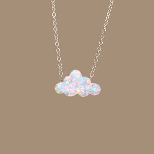 May include: A silver chain necklace with a white opal cloud pendant.