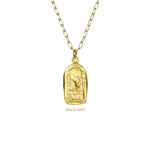 May include: Gold necklace with a pendant featuring an intricate design. The pendant is shaped like a rectangle with rounded corners and has a raised design on the front. The back of the pendant is plain. The necklace is made of a delicate chain.