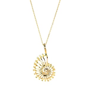 May include: A gold necklace with a delicate, spiral-shaped pendant. The pendant is made of thin, interconnected wires that create a detailed, intricate design.