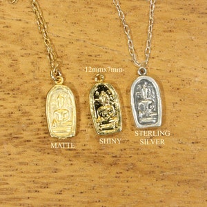May include: Three necklaces with pendants featuring a Buddha figure. The pendants are 12mm x 7mm and come in matte gold, shiny gold, and sterling silver.