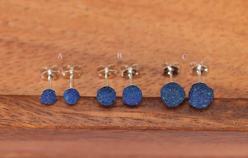 May include: Three pairs of silver stud earrings with blue azurite stones. The stones are different sizes, with the smallest pair labeled 'A', the medium pair labeled 'B', and the largest pair labeled 'C'.
