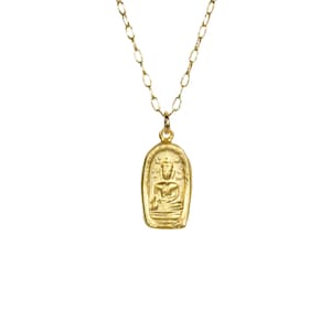 May include: A gold necklace with a pendant featuring a detailed image of a seated Buddha. The pendant is in the shape of a rectangle with rounded edges.