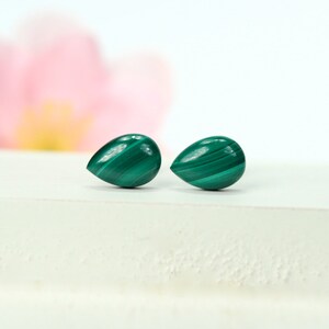 May include: Two green malachite teardrop shaped gemstone earrings.