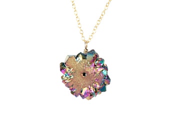Peut inclure: Un collier en chaîne dorée avec un pendentif en cristal iridescent. Le cristal est un groupe de pointes avec un trou au centre. Le cristal est un arc-en-ciel de couleurs, y compris le violet, le bleu, le vert et l'or.