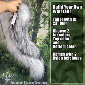 May include: A gray and white faux fur wolf tail, 23 inches long, held by a hand. The tail has a fluffy texture and is designed with two fur color options. The text reads "Build Your Own Wolf tail!" and "Aunumart Custom Creations."