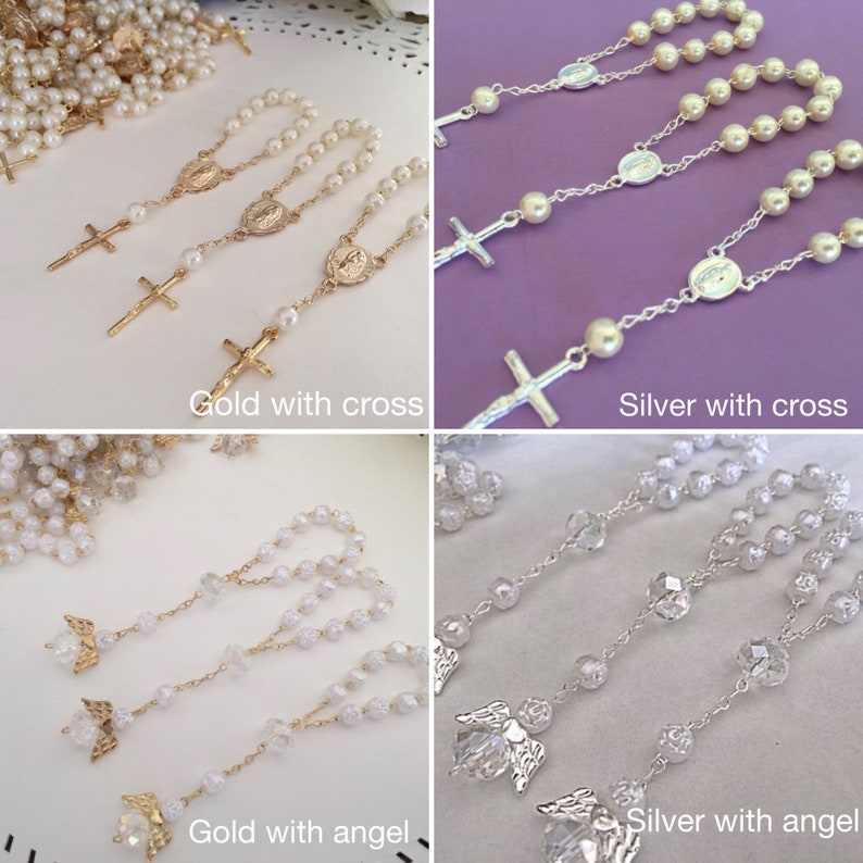 May include: Four sets of white pearl rosaries with either a gold or silver cross or angel charm. The rosaries are displayed on a purple, pink, and white background.