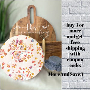 May include: A floral patterned reusable food wrap with a wooden chopping board and a dough whisk in the background. The text "lhs LITTLE HOMEMADE SHOP" is on the chopping board. The text "buy 3 or more and get free shipping with coupon code: MoreAndSave3" is on a white brick background.